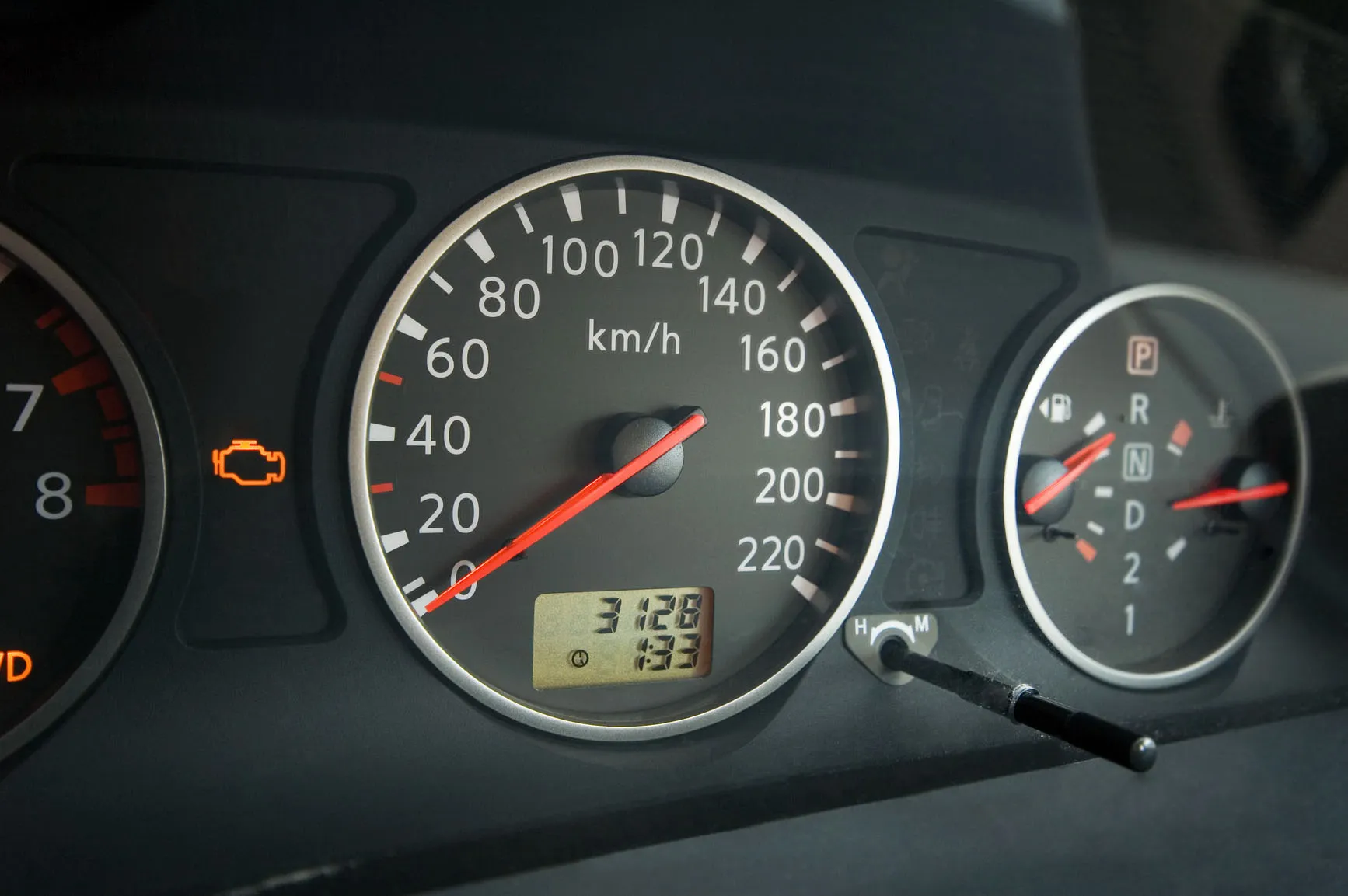 Close-up of car dashboard with speedometer